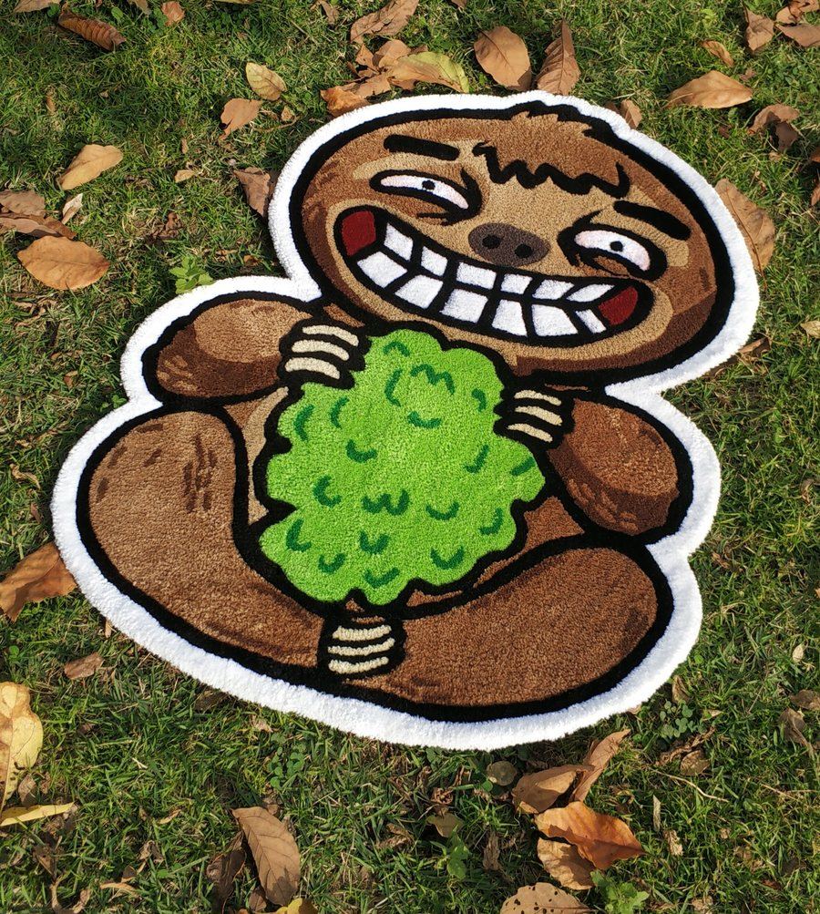 Tapete de uma preguiça segurando um arbusto verde